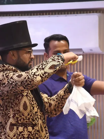 A guest from the audience helps me with a colorful silk handkerchief trick. My interactive magic is perfect for breaking the ice at corporate parties and family functions.