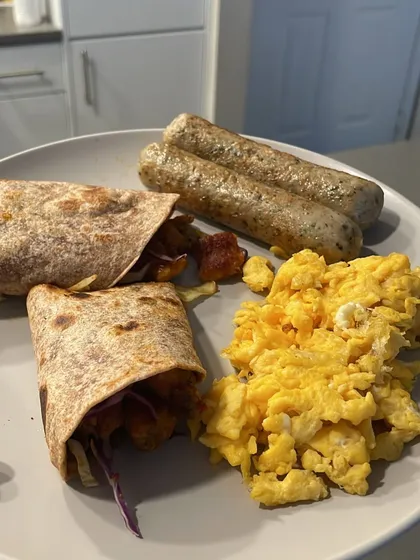 A perfect example of a power-packed breakfast to fuel your day. This plate has whole-wheat wraps, fluffy scrambled eggs, and chicken sausages, providing a great balance of protein, carbs, and fats to keep you full and energized.