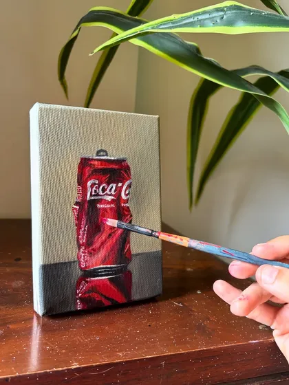 Finding beauty in everyday objects is a passion of mine. This realistic oil painting of a crushed Coca-Cola can is a perfect example of turning the mundane into a piece of pop art.