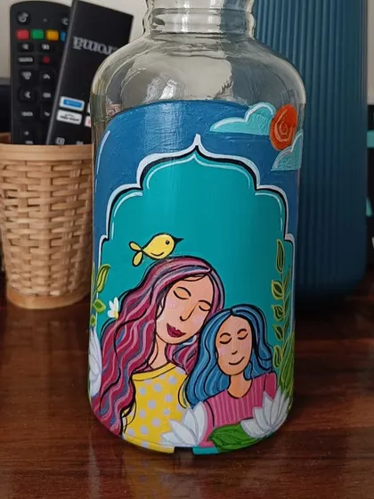 This jar, painted during our workshop, features a colorful and stylized portrait of a mother and daughter.