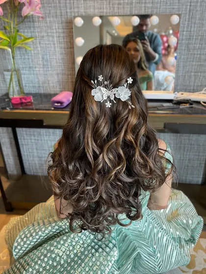 Another angle of the half updo, showing the delicate, butterfly like hair accessory.