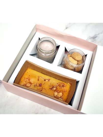 My Diwali Goodies Bag option, featuring a Badam Rawa Loaf, jars of blueberry baked yogurt, and bite-sized Nankhatai. A simple, elegant, and delicious gift.