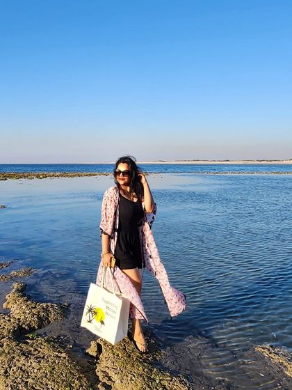 Another angle of the beach look, capturing the beautiful blue water and the effortless style of the outfit.