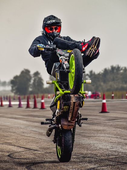 Another angle of the "high chair" wheelie, showcasing the rider's complete control over the machine.