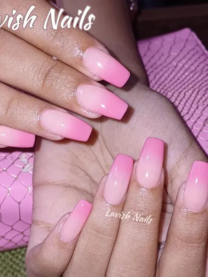 A beautiful pink ombre on square nails, blending from a natural nude to a bright, cheerful pink.