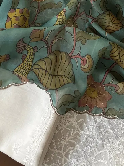 A close-up of the Kalamkari dupatta's border against the Chikankari fabric.