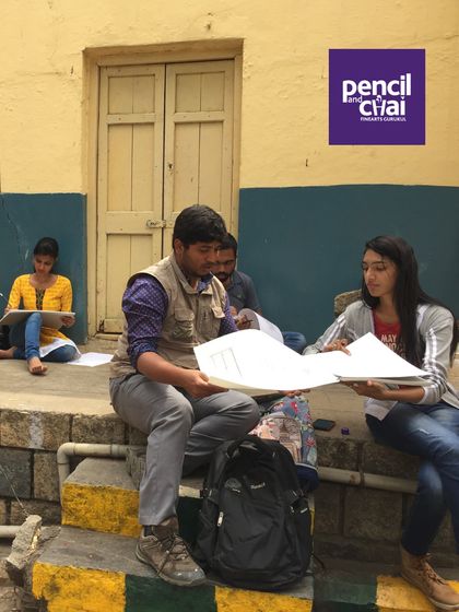 An instructor reviews a student's work during an outdoor session. These on-the-spot critiques are crucial for learning to sketch from life.