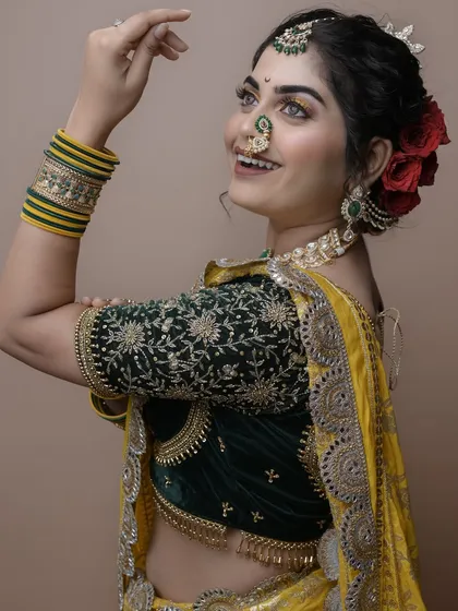 The joy on the model's face says it all. This student's work on a Maharashtrian bridal look is vibrant and beautifully executed.