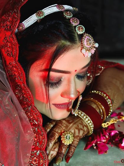 A similar bridal portrait with eyes closed, focusing on the detailed eye makeup and serene expression.