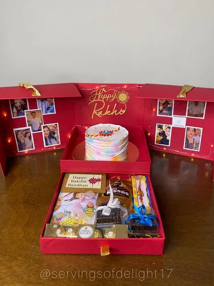 Another angle of the Rakhi explosion box, showing how all the elements come together. The colourful cake, the warm glow of the lights, and the assortment of treats make it a truly memorable gift.