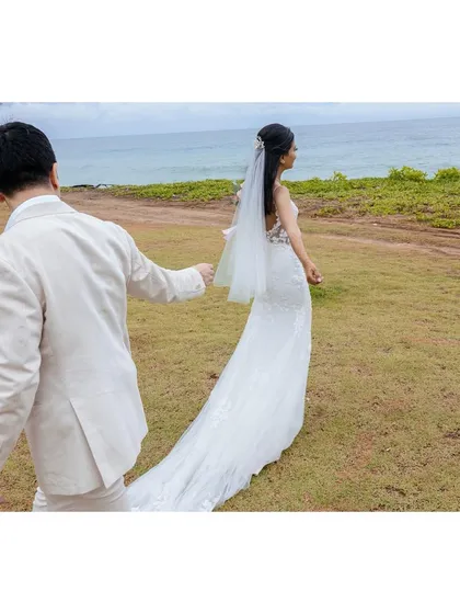 Shachi and Nick share a moment on the beach in Phuket after their Chinese tea ceremony. The beautiful scenery and their traditional outfits create a stunning destination wedding portrait.