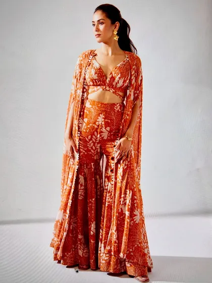 For Mira Kapoor, we chose this vibrant orange printed co-ord set with a dramatic cape. It’s a fantastic example of a trendy, indo-western outfit that’s perfect for a destination wedding or a sundowner party.