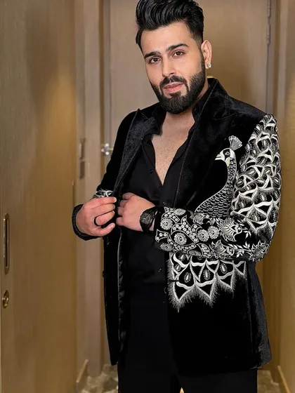 This black velvet tuxedo jacket features a bold, handcrafted peacock motif embroidered in silver thread and beadwork. It’s a statement piece that showcases your personality and my commitment to unique, artistic design.