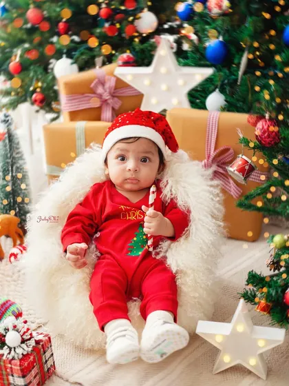 This little Santa's helper is sitting so sweetly by the Christmas tree. My studio is fully decorated for holiday mini-sessions to make them extra special.
