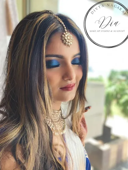 A bold and classy blue smoky eye. I love playing with colour, and this electric blue eyeshadow paired with a simple maang tikka creates a modern and edgy look.