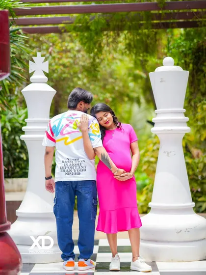 A playful and unique maternity shot on a giant chessboard. This creative setting adds a fun and memorable element to your modern pregnancy photoshoot.