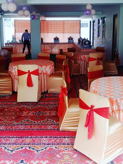 Another angle of the event setup, showing the coordinated chair covers and table linens that my team arranged to match the client's theme.