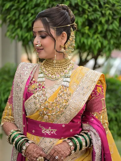 A close-up of the bride's engagement look. The personalized belt with her name adds a modern touch to the traditional attire, which I complemented with a timeless makeup look.