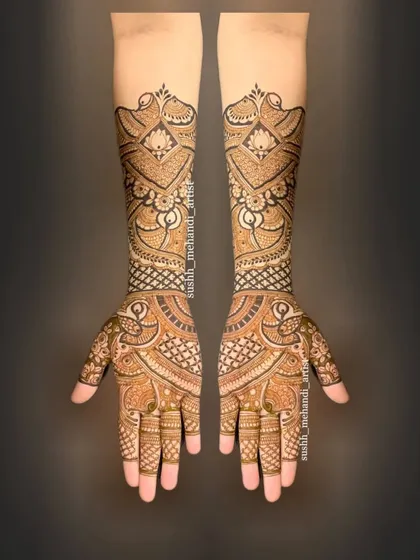This design showcases a unique flow, with paisley and floral patterns weaving up the arms. It's a modern take on a full bridal mehandi.