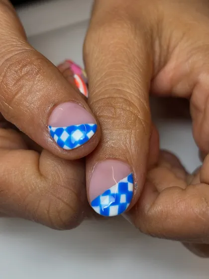 A close-up of the blue and white checkered pattern from the fruity nail set. This highlights the precision and clean lines I achieve in my hand-painted work.