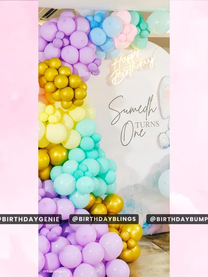 A close-up of the pastel balloon garland, showing the beautiful blend of purple, yellow, teal, and gold.
