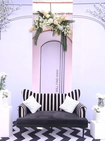 A bold black-and-white striped sofa set against a line-art background, creating a high-contrast, graphic, and stylish seating area.