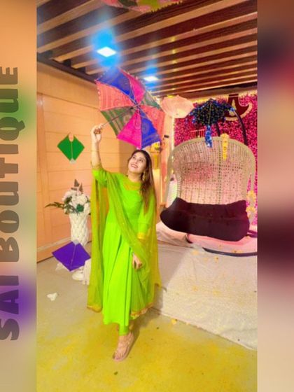 A green beauty celebrating Teej in a bright parrot green suit.