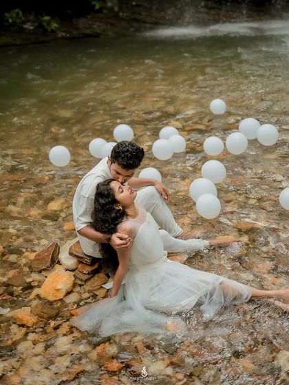 A romantic kiss on the forehead. This pose, combined with the stunning waterfall location, creates a truly epic and emotional photograph.