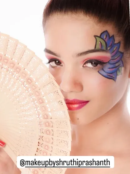 Editorial work allows for more creativity. This is an example of an artistic makeup look, featuring bold face paint and dramatic eyes, perfect for fashion photoshoots that require a unique and expressive style.