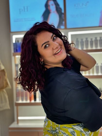 Another happy shot of her new curly look. The color is rich and vibrant, and her curls are full of life.