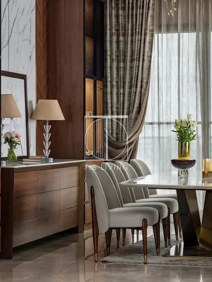 We designed this dining area to be the heart of the home, a place for gatherings and memories. The dining table, with its hand-sculpted brass base and Michelangelo stone top, is a statement of craftsmanship, paired with chairs designed for long, comfortable conversations.