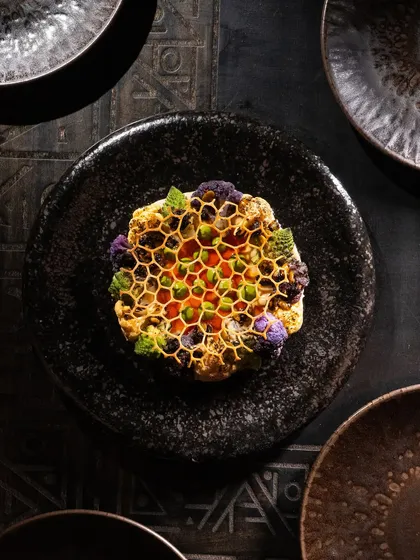 An artistic shot of a complex cauliflower dish, showcasing creative plating. This highlights my ability to shoot high-concept, fine-dining creations.