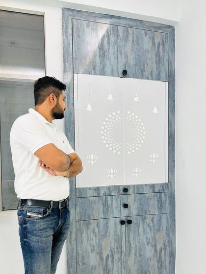 Another view of the grey textured mandir, showcasing the clean lines and contemporary aesthetic.