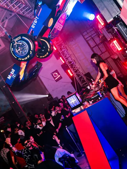 A different angle of the insane Red Bull setup. DJing underneath a suspended Formula 1 car is definitely a career highlight and shows how creative brand events can be.
