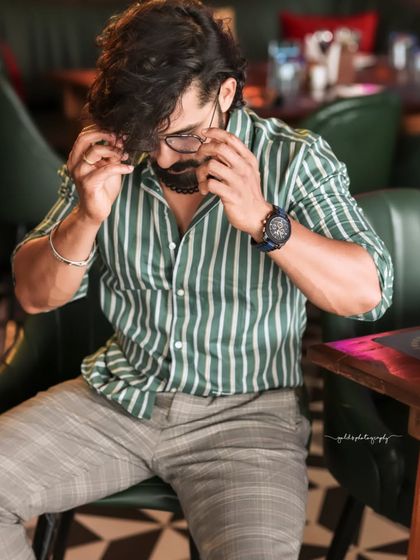 A collection of indoor portraits of an actor in a stylishly casual striped shirt. The moody lighting of the cafe setting adds a cinematic and modern feel, perfect for a character portfolio.