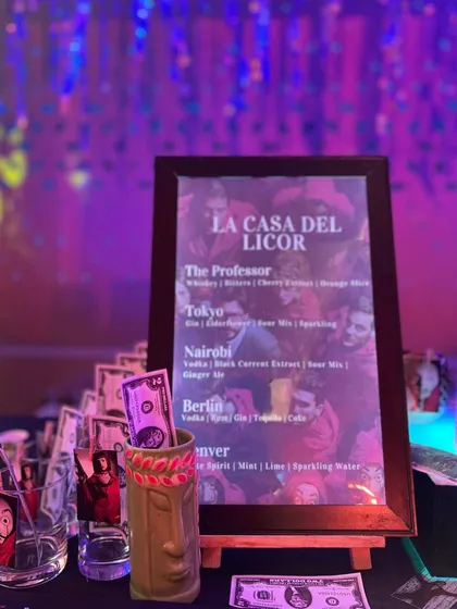 Our custom cocktail menu, "La Casa Del Licor," features drinks named after the show's characters, like 'The Professor' and 'Tokyo'. Each drink is designed to match the theme.