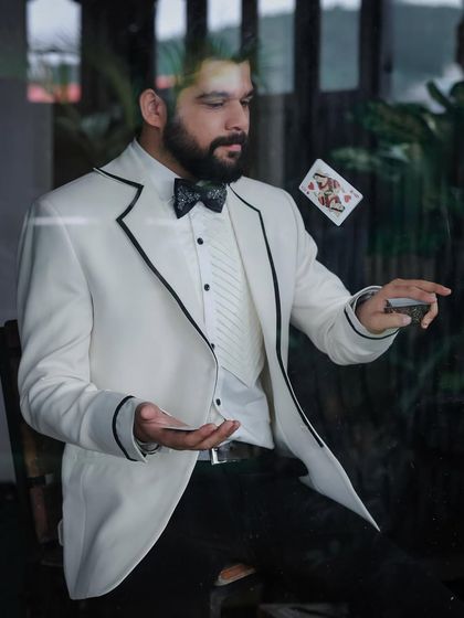 This creative shot captures the playful and magical theme of the photoshoot with Kshitish Date, with the tuxedo adding a touch of classic showmanship.