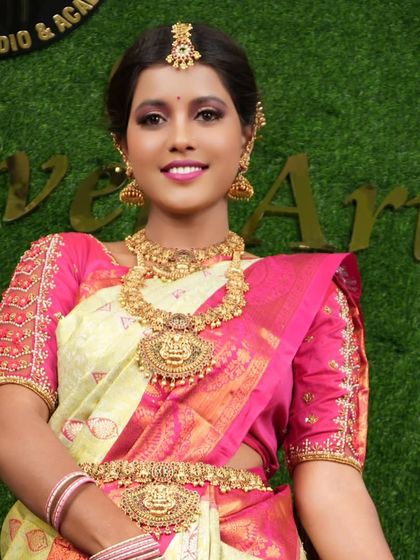 This bride looks radiant in a temple jewellery set paired with a light-colored silk saree. The contrast is beautiful.