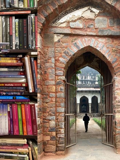 A view from a bookstore looking out into the arched gateway of a historical monument, blending my love for books and heritage.