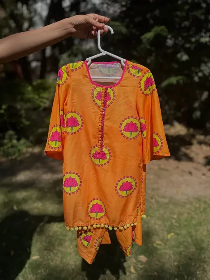Beat the heat in style with this summer-ready orange kurta set. The fabric is soft, and the lotus print is so cheerful.