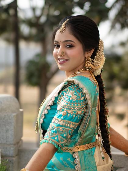 A view of a long, traditional bridal braid. This hairstyle is a classic for South Indian weddings and looks stunning with a Kanjivaram saree.