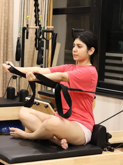 Building strong arms, open shoulders, and a lifted posture is achievable with focused exercises on the Reformer. This seated row variation targets the upper back and improves postural alignment.