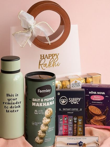 A healthy and fun Rakhi gift for your brother. This hamper features a reminder water bottle, salt & pepper makhana, Sleepy Owl coffee, an evil eye rakhi, and other tasty treats.