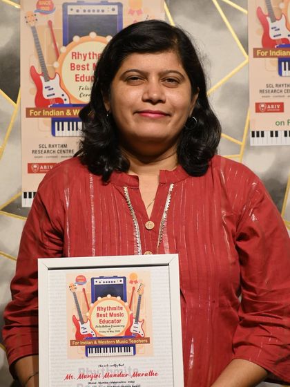 Ms. Manjiri Mandar Marathe, recognized with the "Rhythmite Best Music Educator" award for her excellence in teaching Tabla. We have a team of award-winning gurus for our percussion classes.
