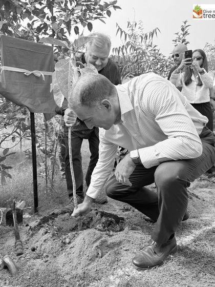 EXL's CFO, Maurizio Nicolelli, planting a tree himself. This act of leadership demonstrates a deep, personal commitment to sustainability that goes beyond corporate reports.