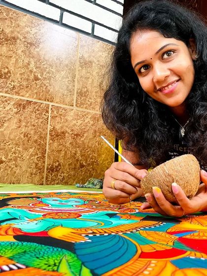 A proud moment, posing with my art. I am using a traditional coconut shell as my paint palette, a little touch from my home.