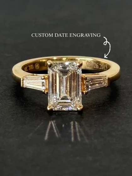 Some dates are not just remembered, they are felt. This emerald-cut solitaire ring holds a quiet detail, a custom date engraved inside the band. It is a memory set in gold, a story that begins on a day worth holding onto forever.
