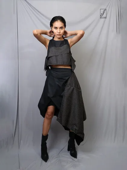 A powerful, symmetrical pose that confronts the camera directly, showcasing both the model's confidence and the outfit's design.