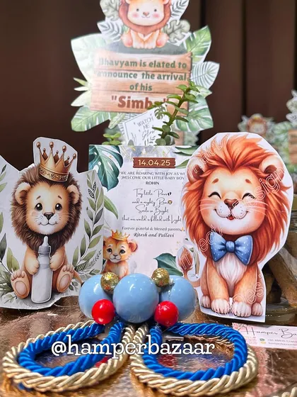 A close-up of our 'Simba' themed baby announcement hamper, showing the personalized card and lion cutouts.