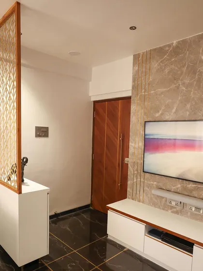 This angle shows the entryway partition and its relationship to the TV unit, demonstrating how we create distinct zones in an open-plan space.